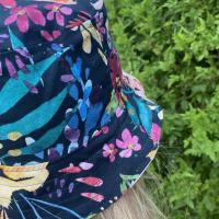 Rear side view close up of black side, worn by adult woman