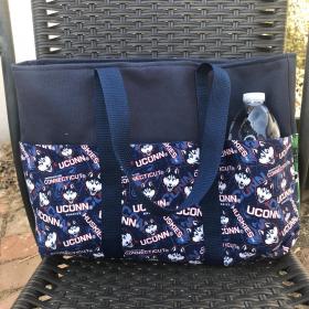 6 exterior pockets, Water bottle (not included) shows scale of bag